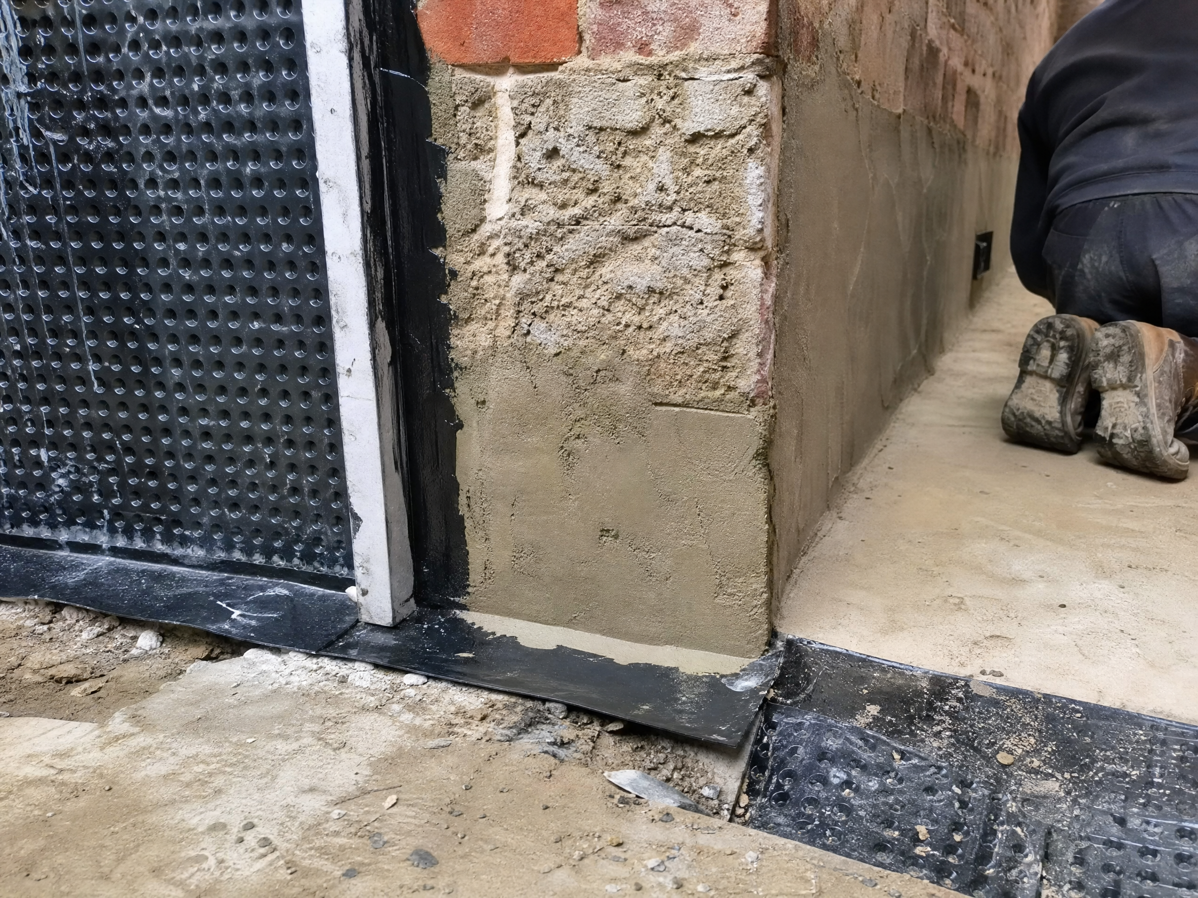 Close-up detail of materials and technique used in cellar tanking — showing quality