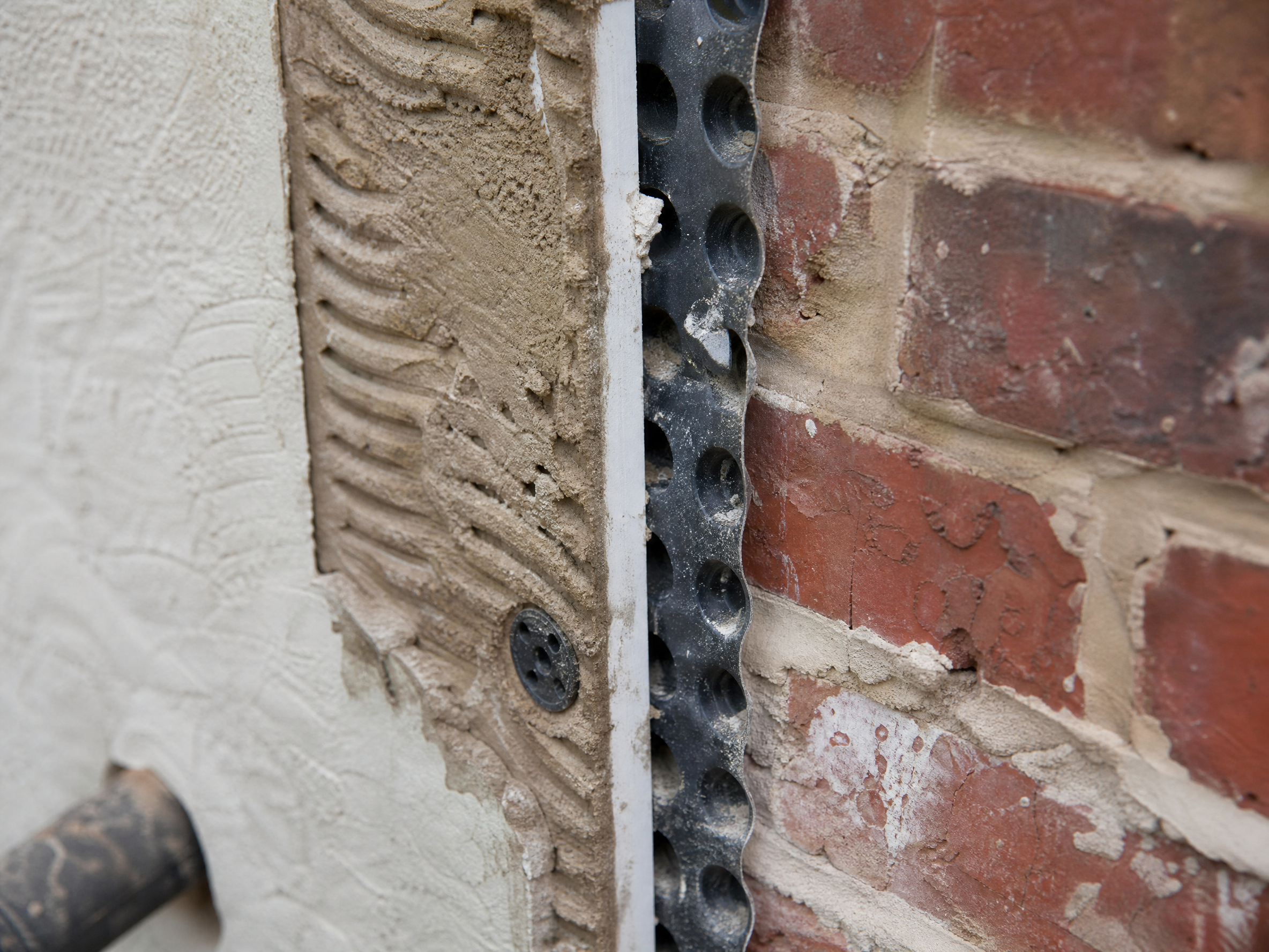 Close-up detail of materials and technique used in damp survey — showing quality